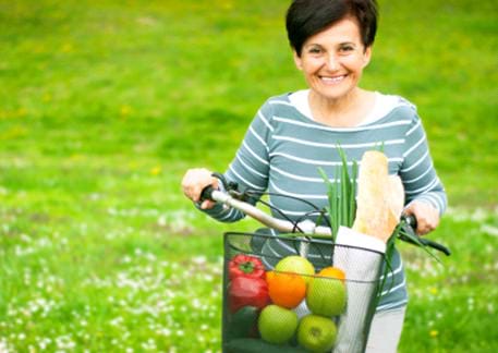 older woman with healthy groceries