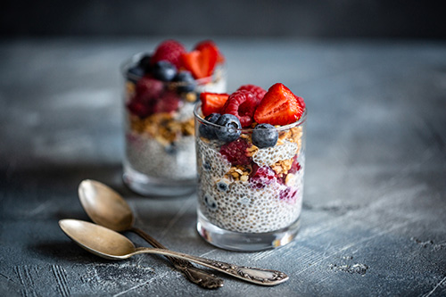 Two cups of chia seed pudding, topped with fruit