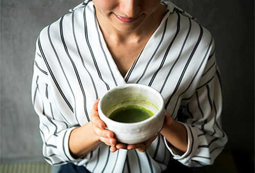 Woman drinking green tea for respiratory health during cold and flu season
