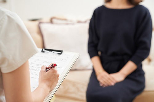 A woman the doctors asking questions about her colonoscopy