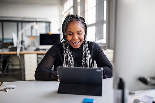 A woman on a video call with her doctor scheduling her pap test