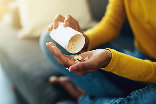 Woman taking multivitamins for her health