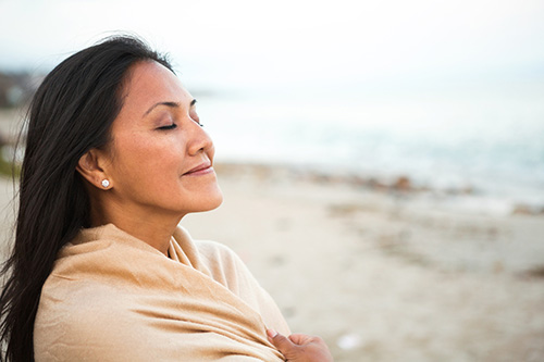 Woman taking a deep breath as she considers her questions about hysterectomy