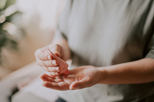 Woman applying hormone cream