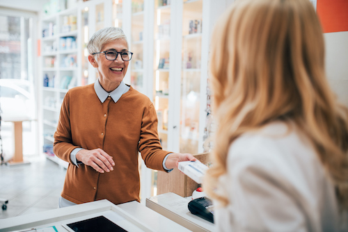 Woman at compounding pharmacy who is worried she lives too far away to pick up HRT prescription