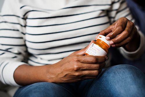 Woman holding a prescription for hormone replacement therapy (HRT) 