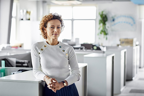 Woman in her office with questions about hysterectomy and hormonal balance