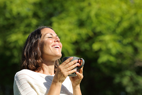 Woman relaxing in the sun enjoying hormonal balance