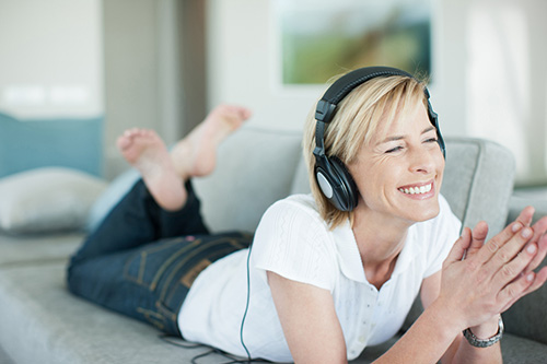 Woman listening to a podcast about her options for hormone replacement therapy and natural options for boosting low libido