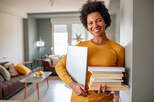 Woman with books looking into the history of synthetic hormone replacement therapy and its risks for women's health