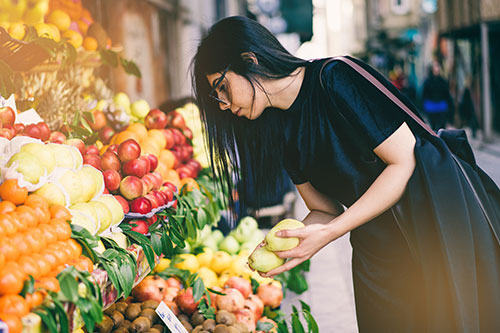 Woman choosing certain foods that help to avoid hot flashes