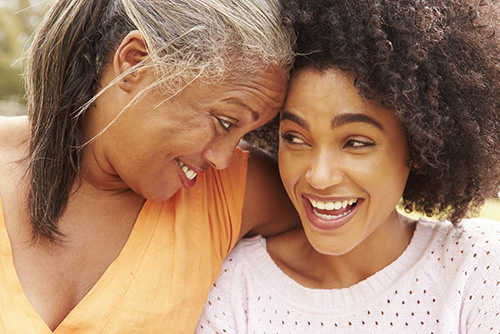 closeup of mother and daughter laughing together