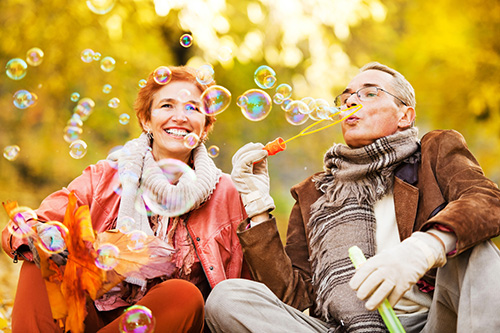 happy couple blowing bubbles