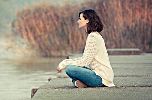 A woman using deep breathing to reduce her anxiety