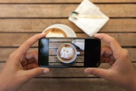 taking a picture of cat face in latte