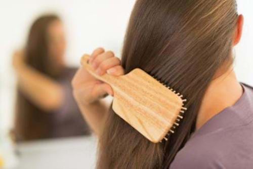 A woman using easy natural tricks to make her thinning hair look fuller