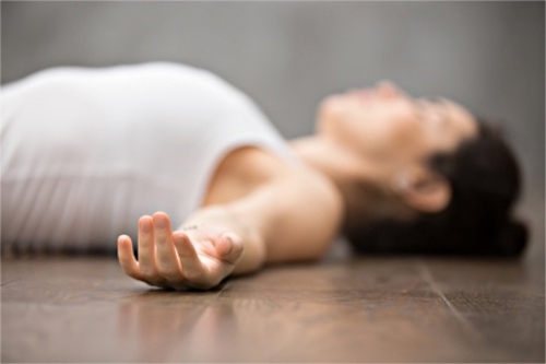 A woman practicing yoga to relieve her migraine