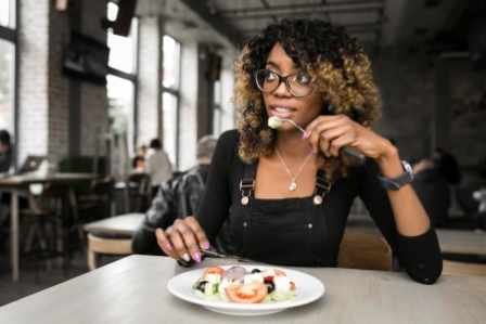 woman eating and worrying about her digestion