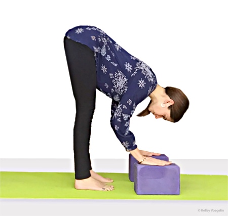 Kelley doing Standing Forward Bend (Uttanasana)