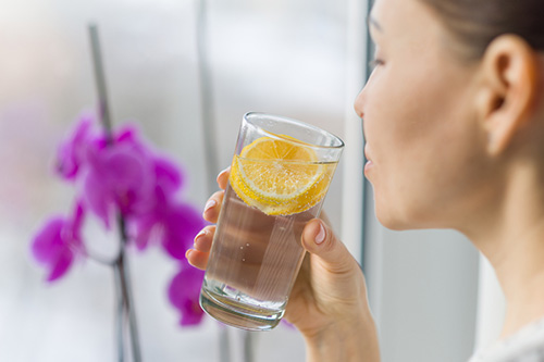 A woman drinking water to relieve her dehydration