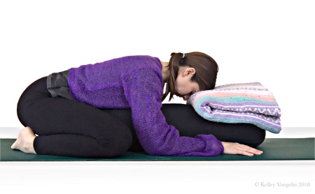 Woman doing Child's Pose in yoga to reduce stress