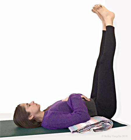 Woman doing Legs-Up-the-Wall Pose in yoga to reduce stress