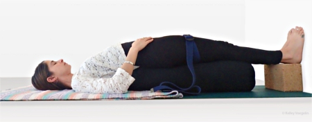 Kelley demonstrating Supported Bridge Pose for thyroid health