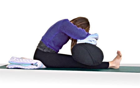 Woman doing Seated Forward Fold yoga pose