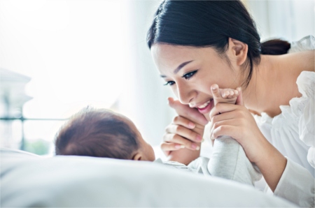 Mother holding her baby's feet