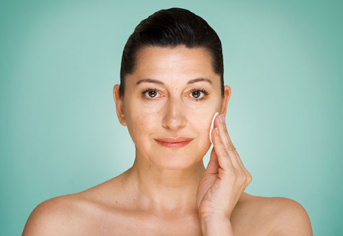 A woman using natural treatments for her hormonal adult acne