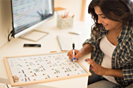Woman tracking her 30 day dairy challenge progress on her calendar woman tracking her dairy challenge progress