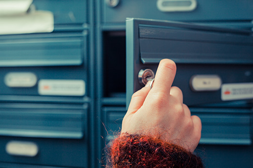 woman's hand opening postal box