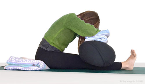 seated forward fold yoga pose helps stretch your lower back