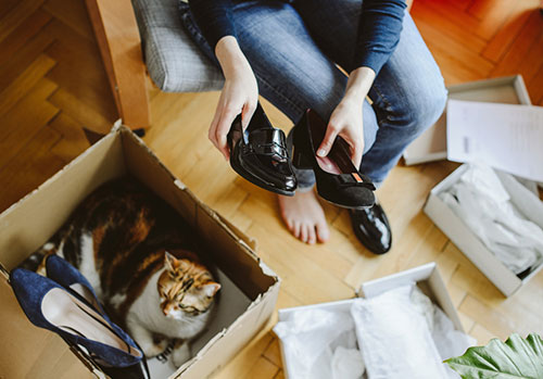 woman looking at shoes she bought online