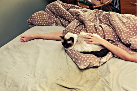 Woman sleeping with cat
