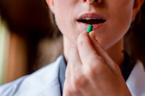 woman taking her prescription medication