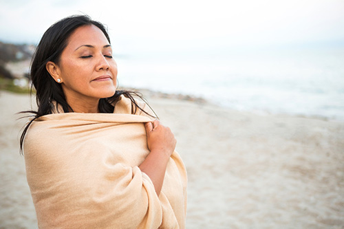 A woman who is using CBD oil to reduce anxiety and feel more relaxed