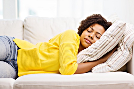 Woman catching up on sleep on couch Woman sleeping on couch