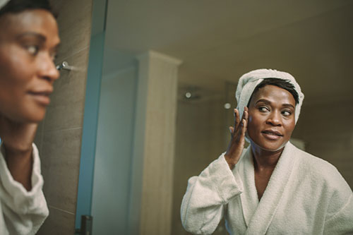 woman performing facial lymphatic massage