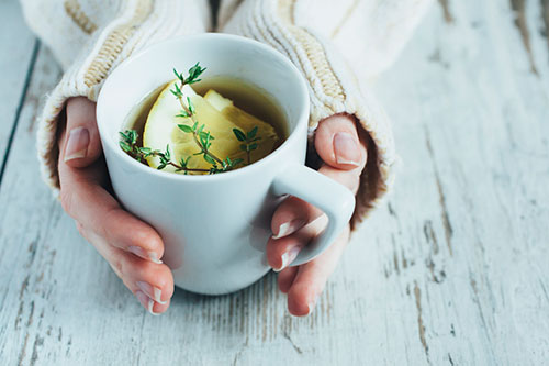 woman holding cup of bone broth