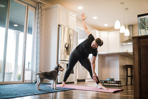 A woman doing yoga to lower her high blood pressure