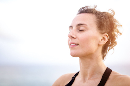 A Woman Practicing Deep Breathing To Stimulate Her Vagus Nerve And Lower Her High Blood Pressure