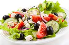 A delicious Greek-style salad with olives and tomatoes delicious Greek-style salad with olives and tomatoes