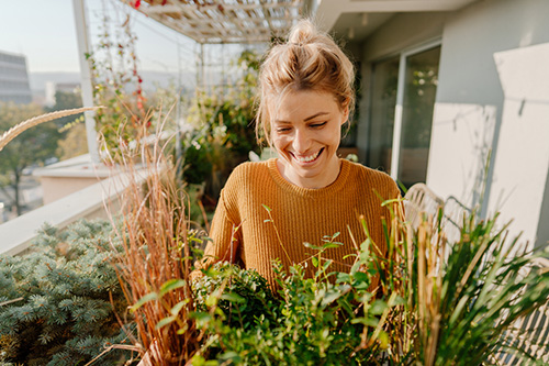 A happy woman gardening after resolving her PMS symptoms