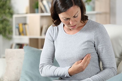 A woman experiencing breast pain