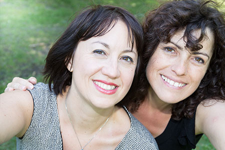 two women take selfies in the park