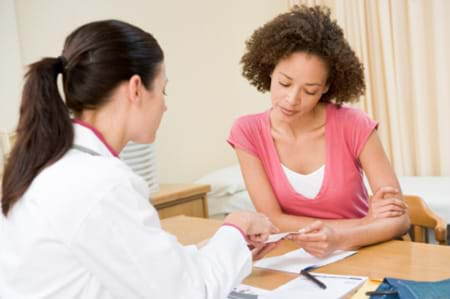 woman going over her test results with her doctor