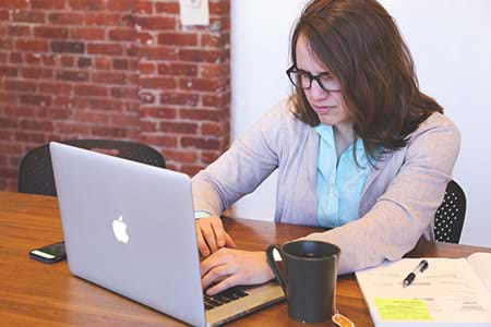 woman on laptop with high stress