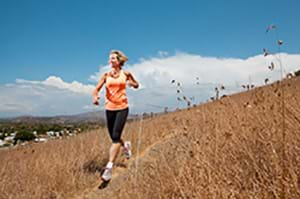 woman running down a trail