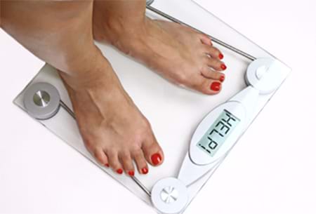 woman standing on bathroom scale needs weight loss tips